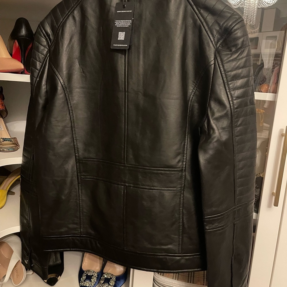 Brand new leather coat from Barneys. My husband could not fit.